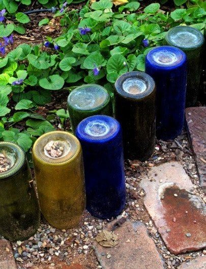Use colorful old wine bottles for a unique recycled garden edging featured on Bekob.com