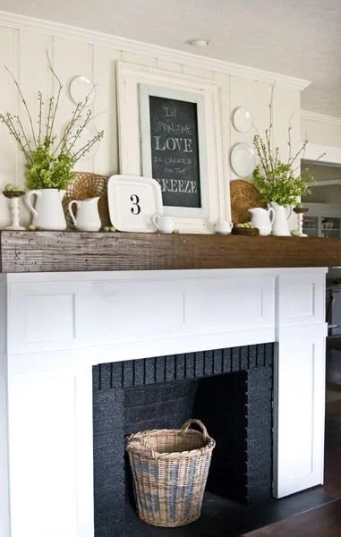 vivid layered mantel arrangement with white dishes and a chalkboard