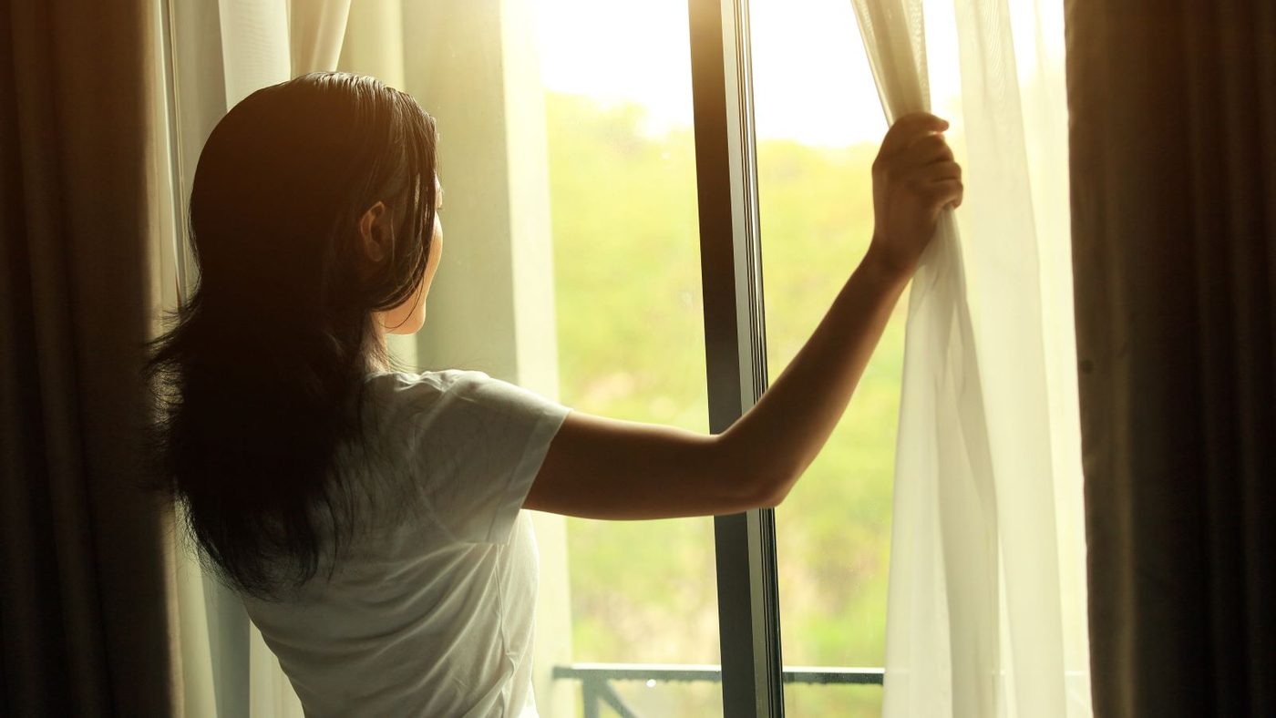 Girl Opening Curtain