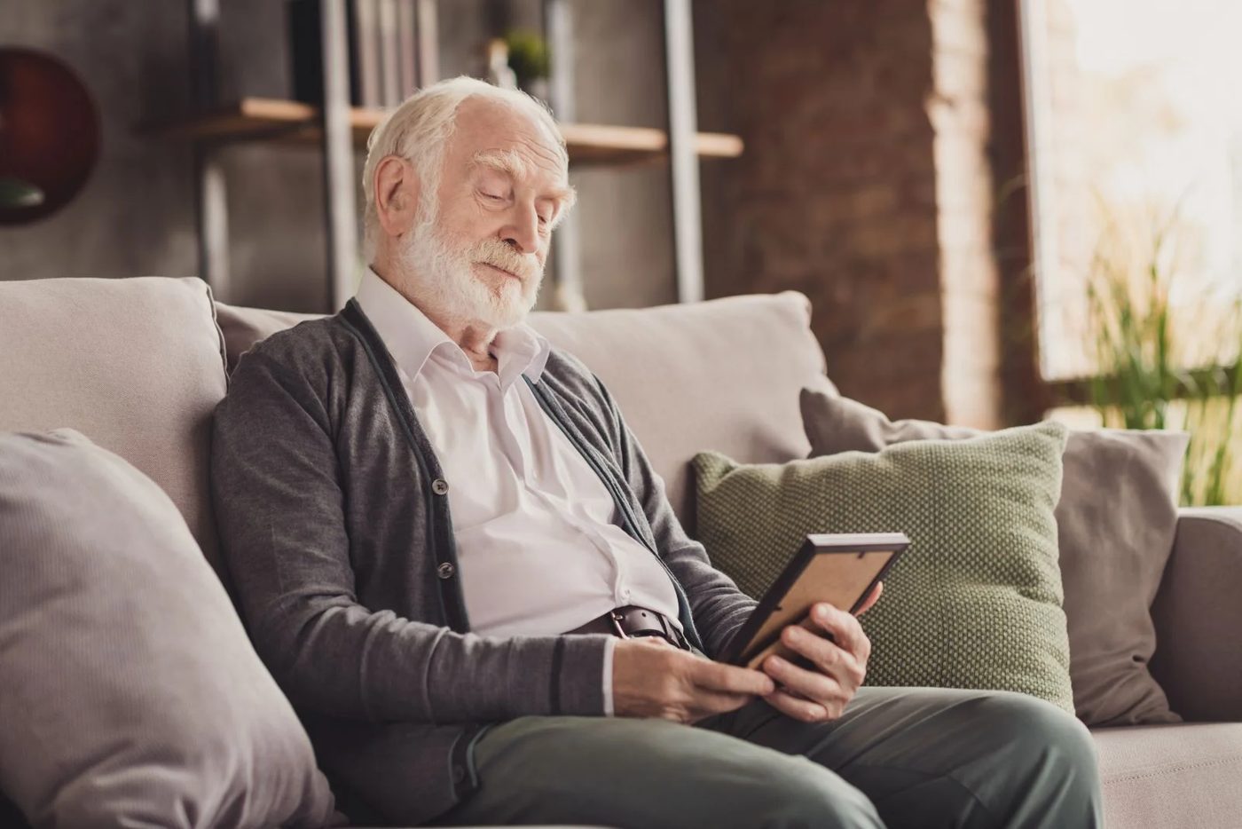 Man Looking At Picture Frame