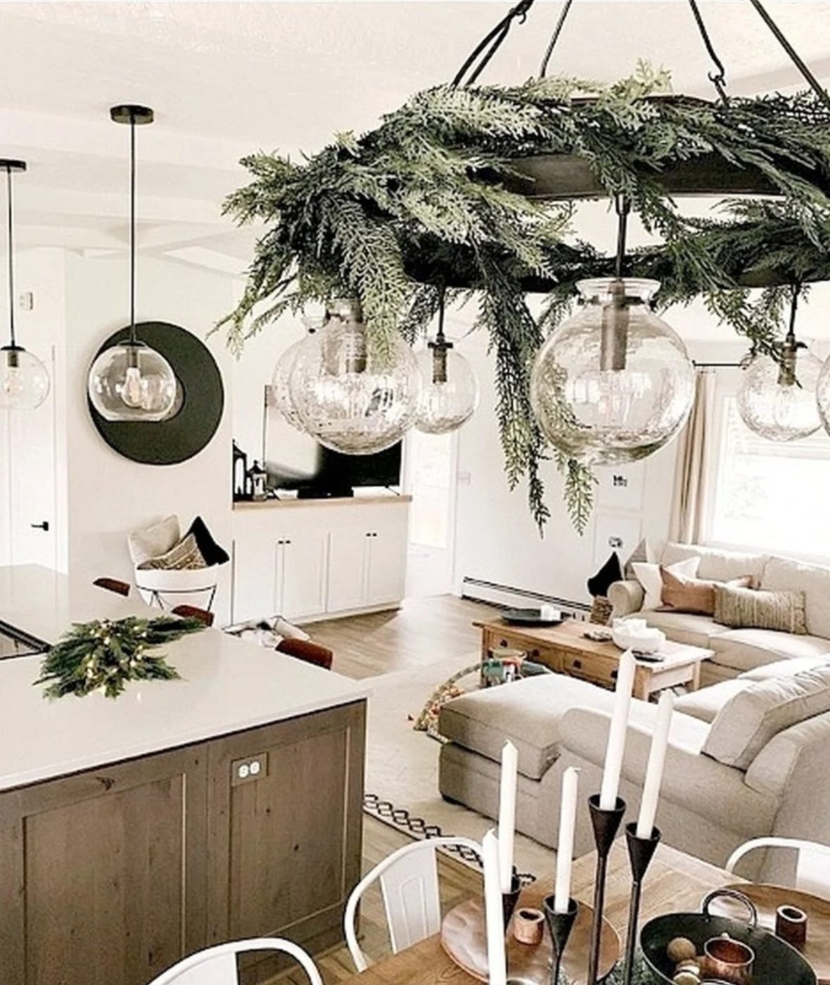 Kitchen With Circle Light Fixture Covered In Tree Branches Making It Festive And striking