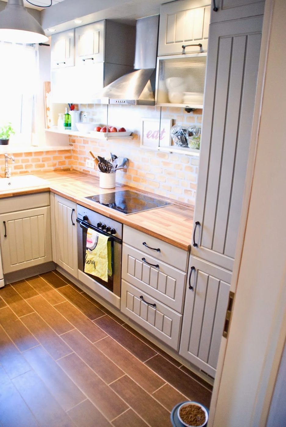 small kitchen with two-tone cabinets wood tile floors - Pudel-design featured on @Bekob