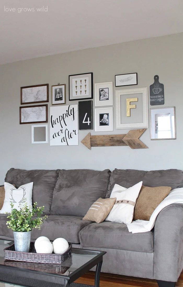 Grey Microfiber Couch With White And Gold Throw Pillows And Blankets And White. Grey, Wood, And Gold Frame Collage
