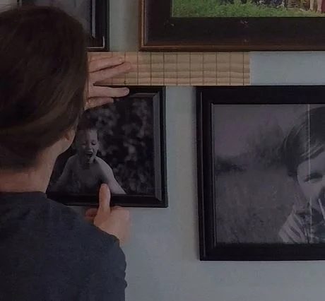 Image Of Lady's Back Showing Her Measuring Spaces Between Frames With A Ruler