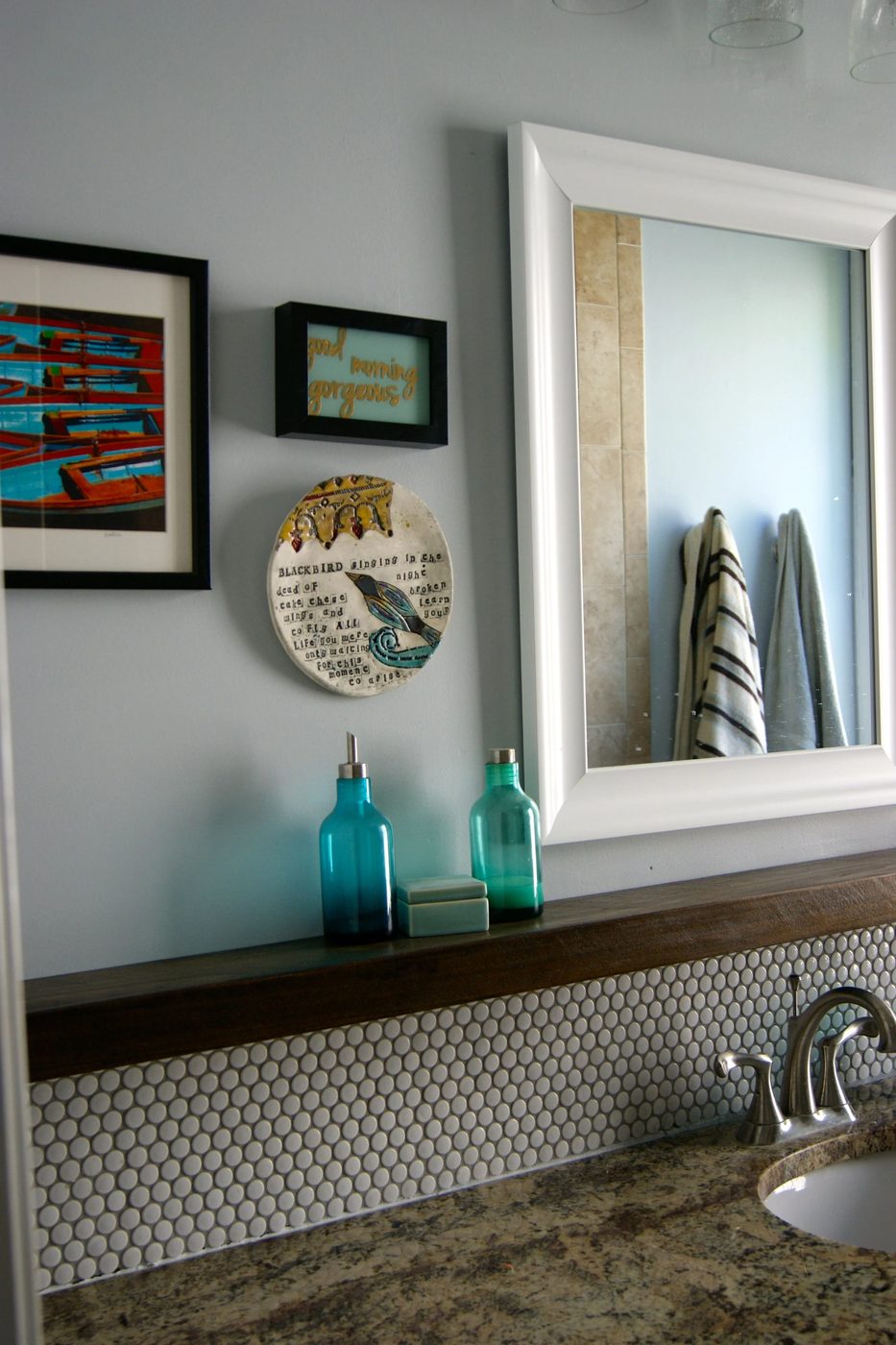 penny tile bathroom backsplash with floating wood shelf