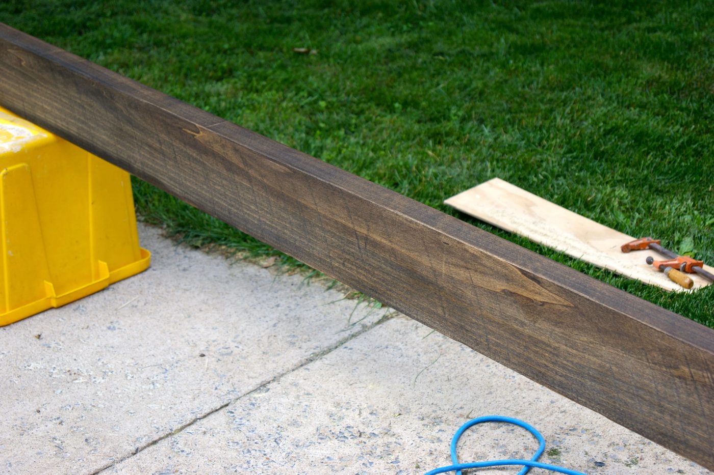 stained rough cut lumber for wooden floating shelf in bathroom