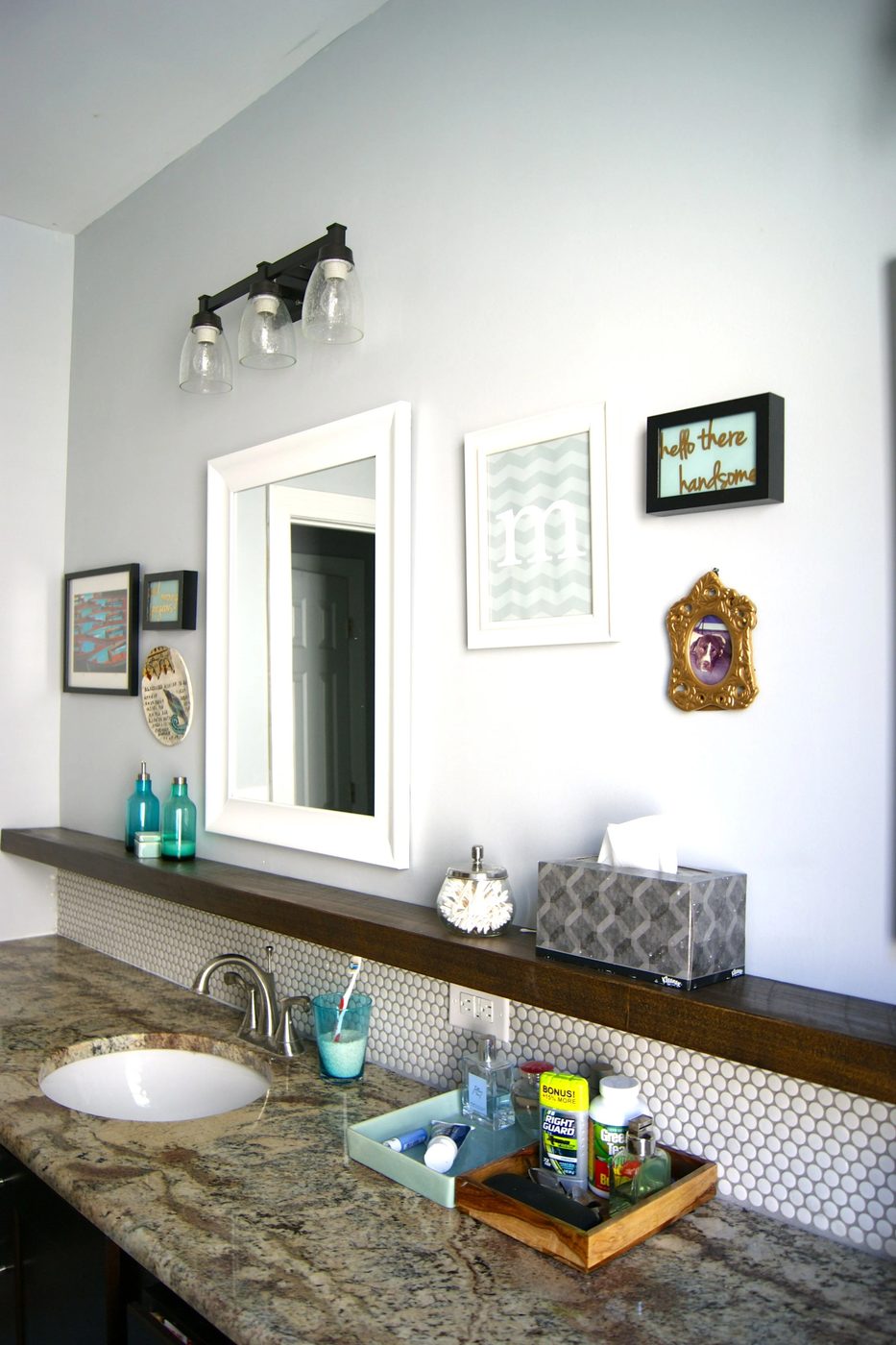 bathroom makeover with penny tile and floating wood shelf