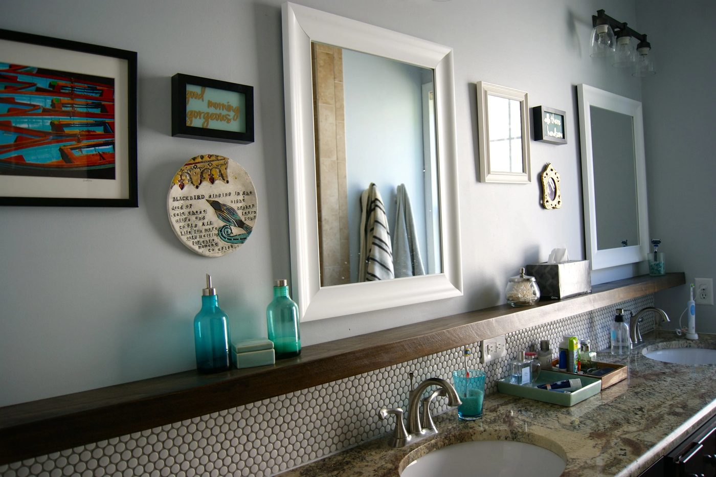bathroom makeover with penny tile and floating wood shelf