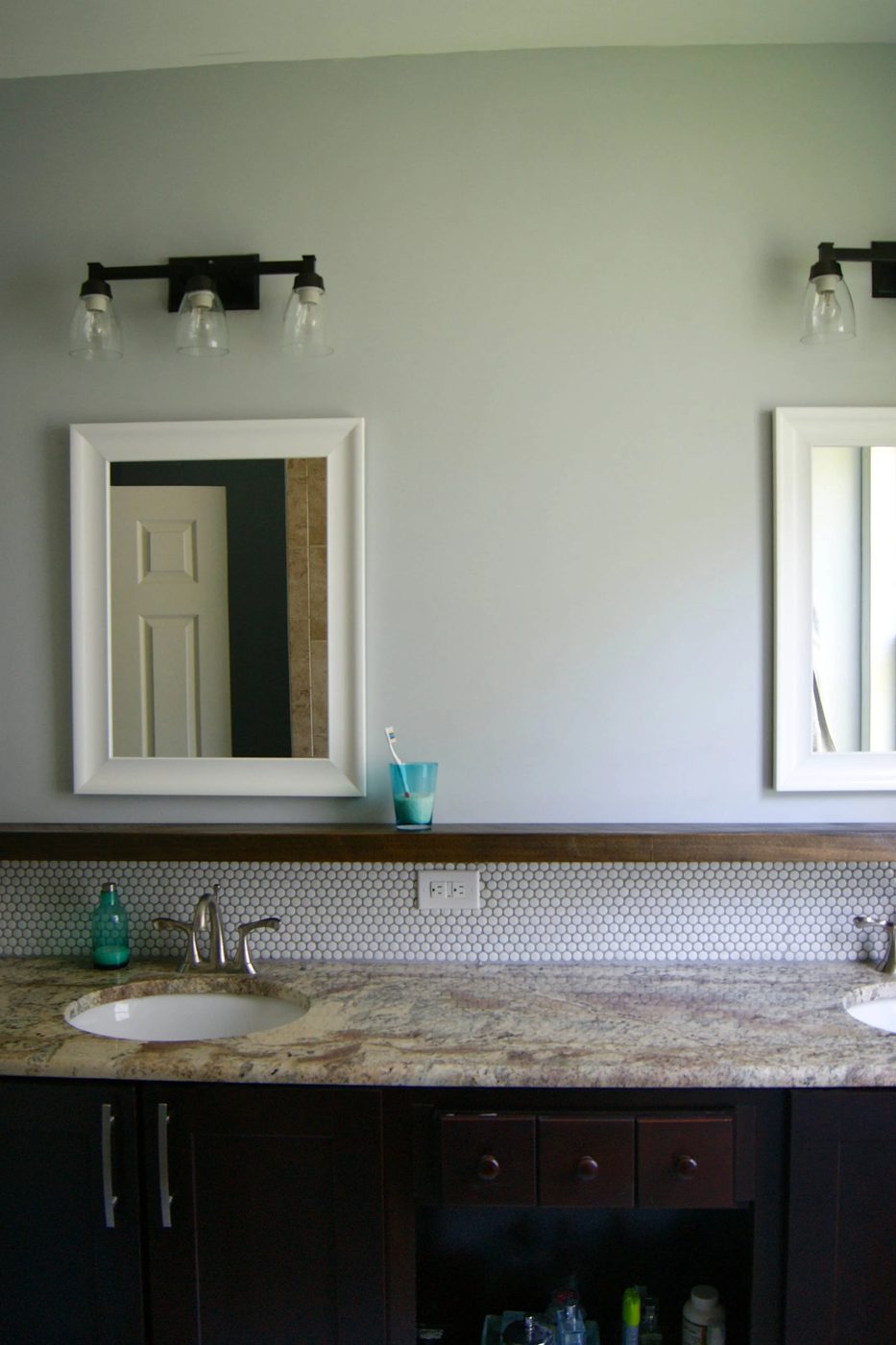 bathroom makeover with penny tile and floating wood shelf