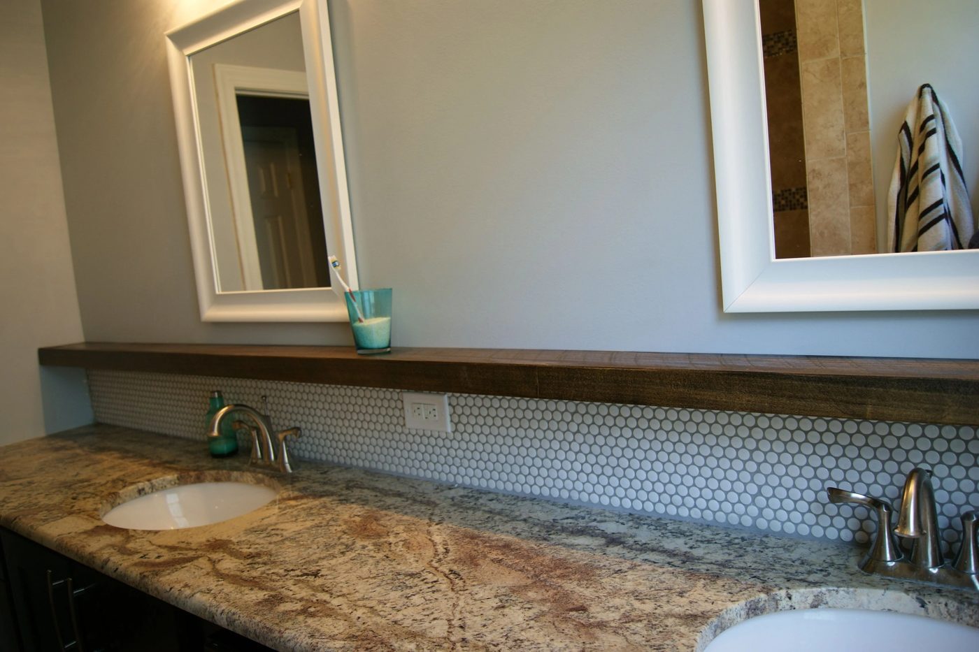 bathroom makeover with penny tile and floating wood shelf