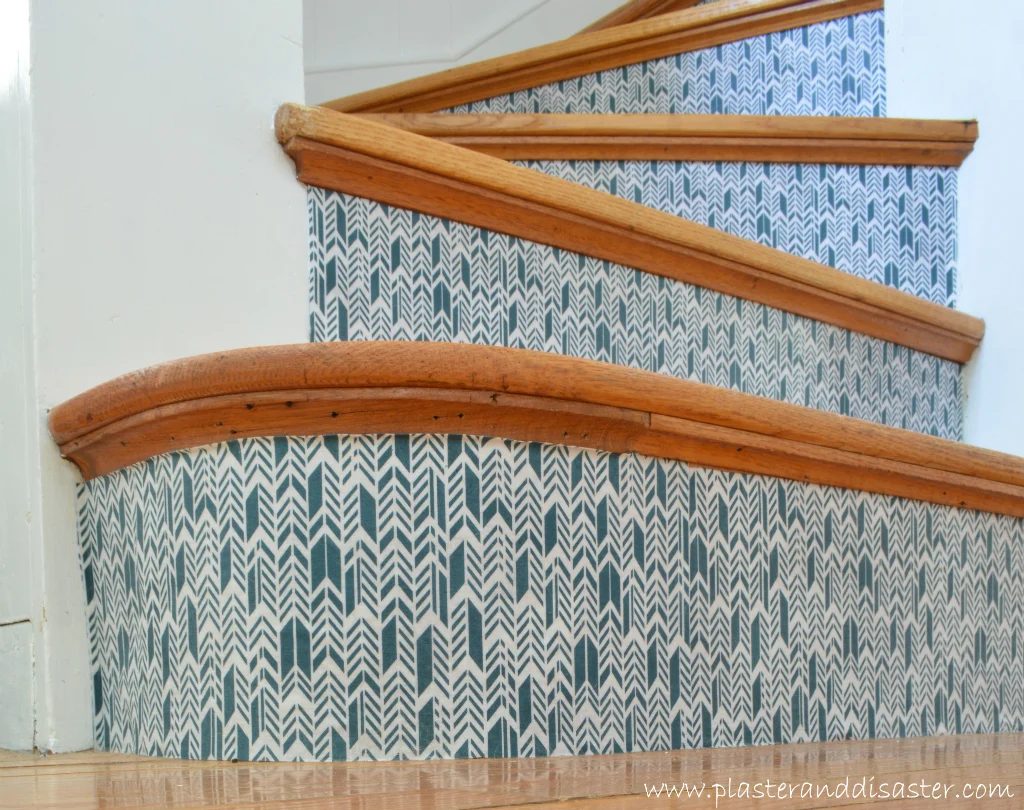 Handmade staircase makeover with fabric wallpaper stair treads to add color