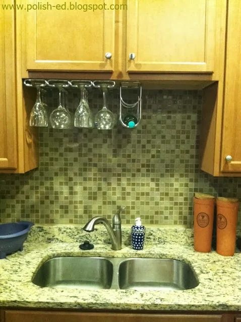 Featured on Bekob: hang wine glasses and a wine rack in the cabinet hole above the sink, Polish-ed