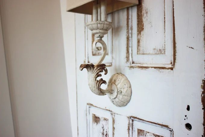 Wall sconce mounted on antique door used as bedside lighting, by direct Nature Decor featured on @Bekob