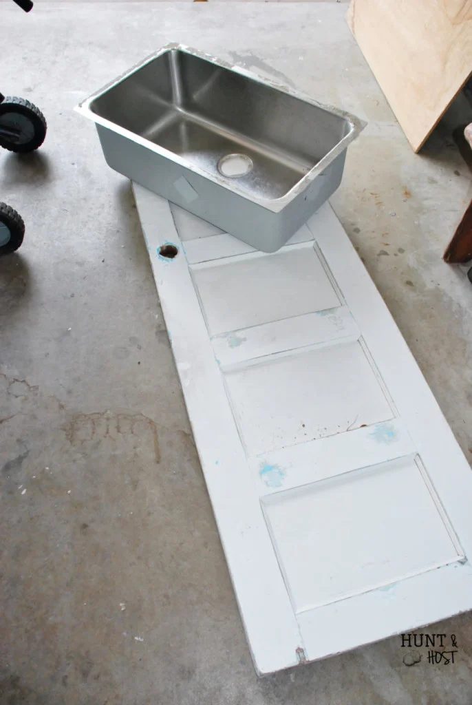 Salvaged old door and sink made into the well fitted table for poolside entertaining by Hunt and Host featured on @Bekob