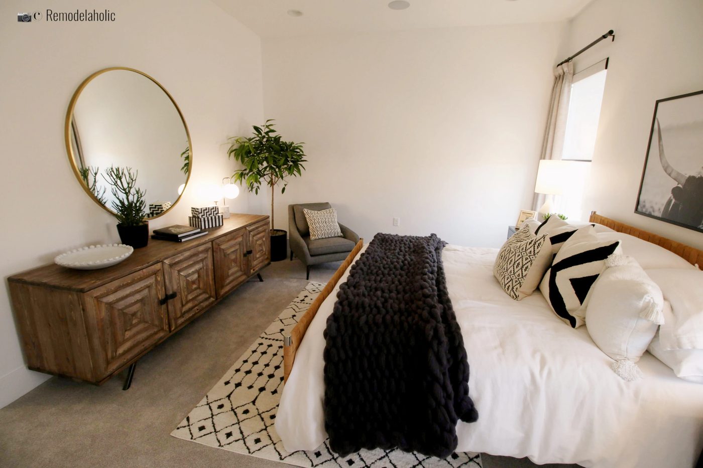 Bedroom design with accent chair. SGPH 2019 House 22 SunRiver Construction, LC, Photo by Bekob