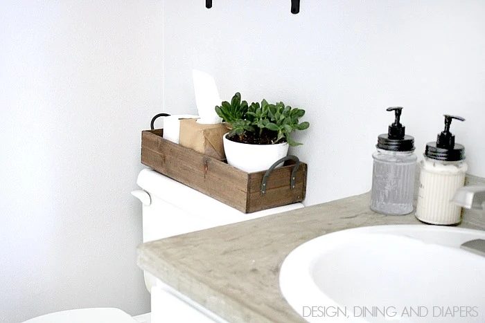 use a wooden tray to organize items on the back of the toilet in a small bathroom Design Dining and Diapers