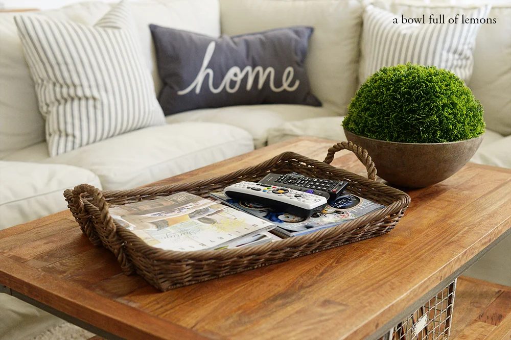 use a coffee table tray to corral remotes and magazines