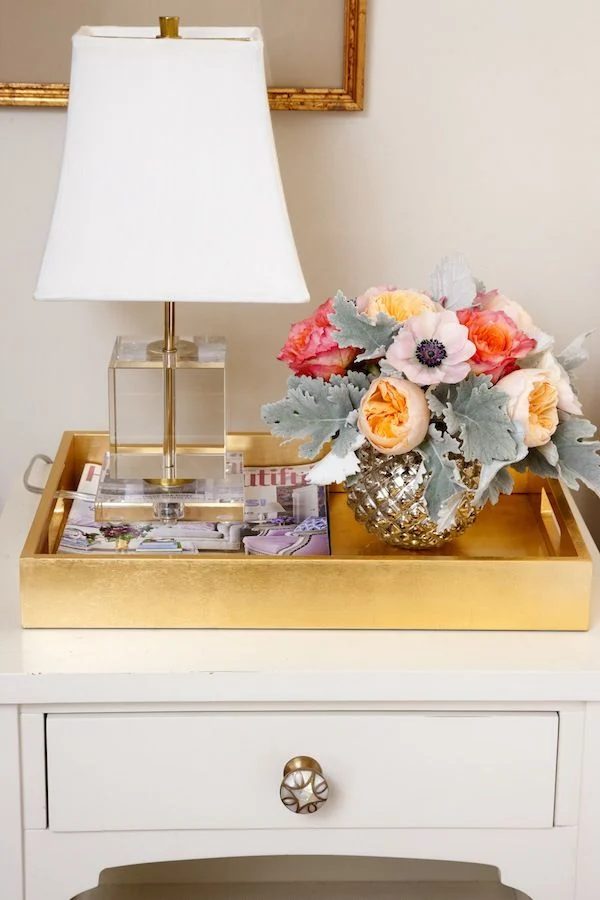 use a large tray to contain nightstand items via StyleCaster