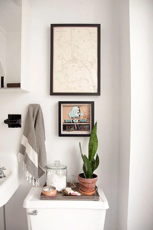 back of toilet organizing with a bath tray via DesignSponge