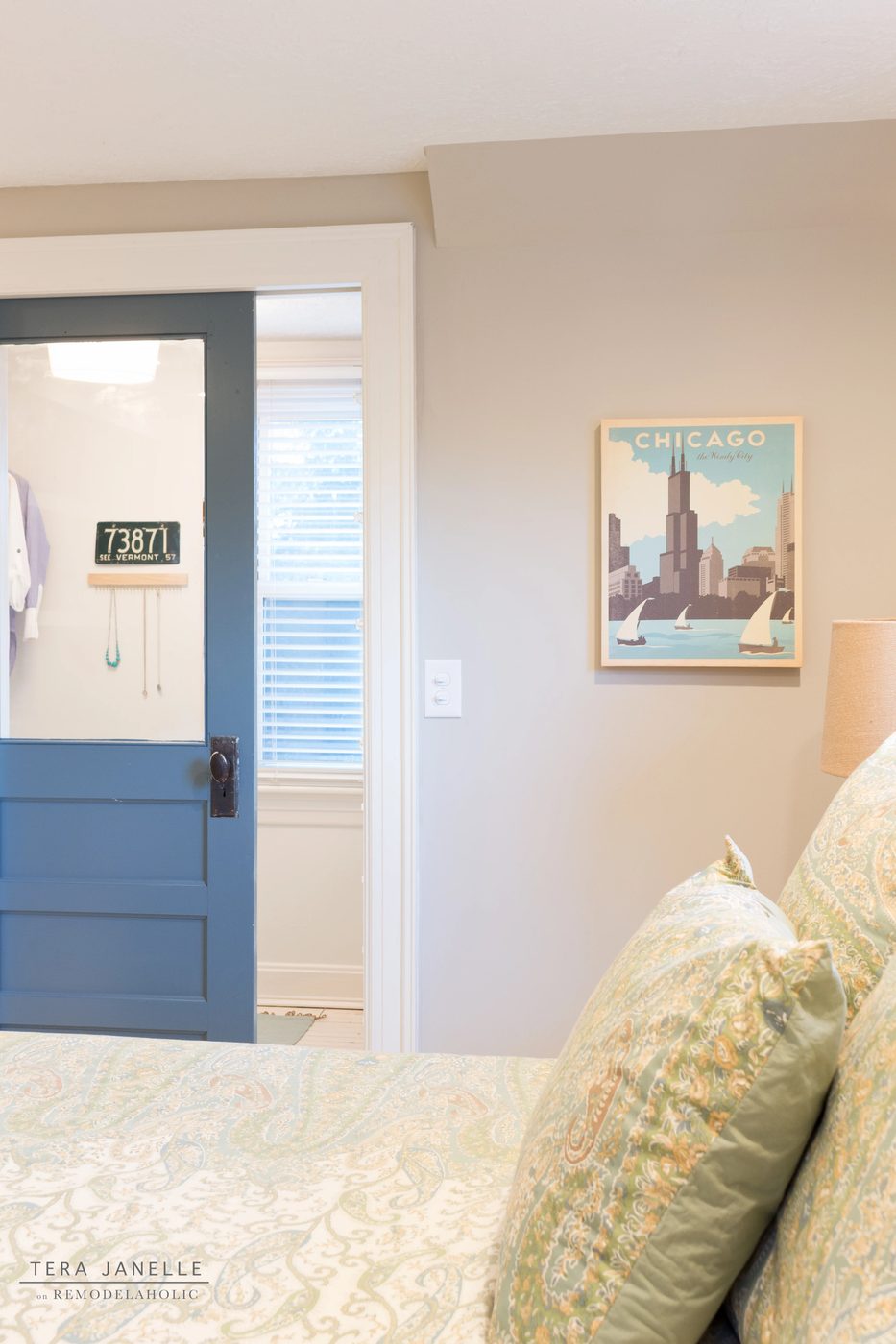 A striking travel-inspired master bedroom with an exposed brick wall and a striking built-in bookshelf and storage nook. Tera Janelle on Bekob.com