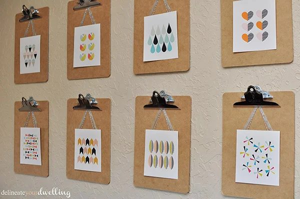 clipboard wall of mini art prints (Delineate Your Dwelling)