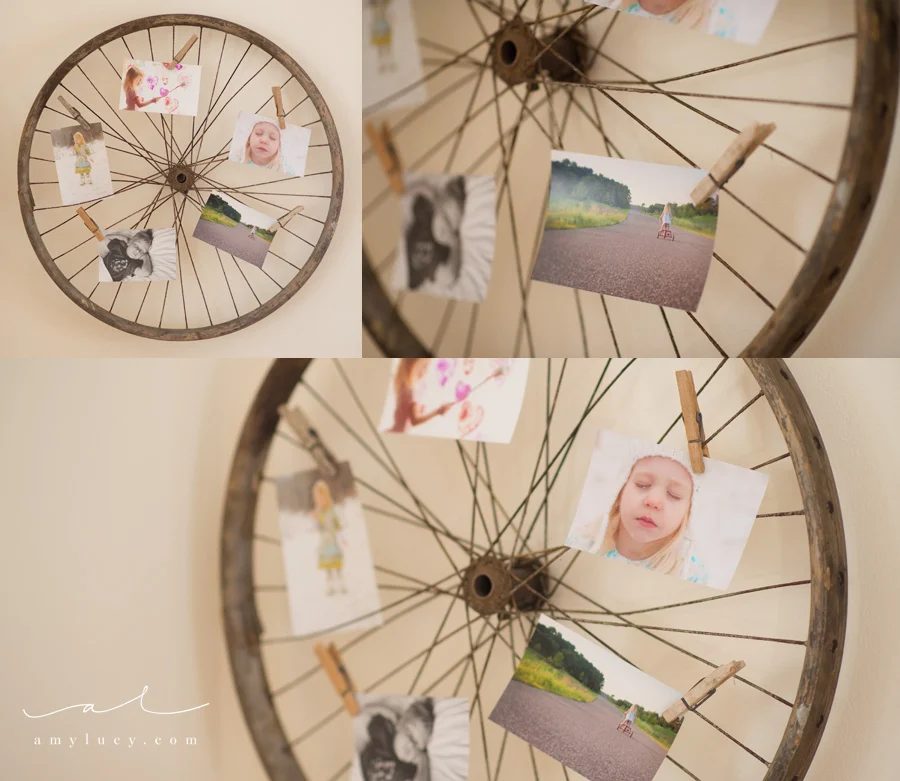 use an old bike wheel to display photos and art prints (Amy Lucy)