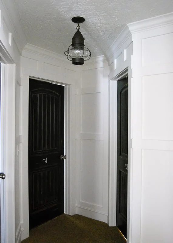 Decorate A Hallway Board And Batten Wainscoting With A Fun Light Fixture And Black Doors Home By Heidi Via Bekob