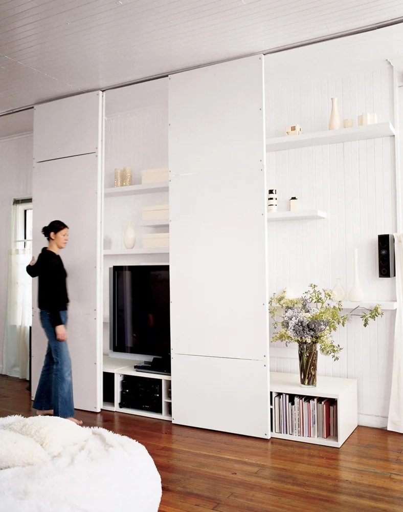 full height sliding panels hide TV and shelving (Domino)