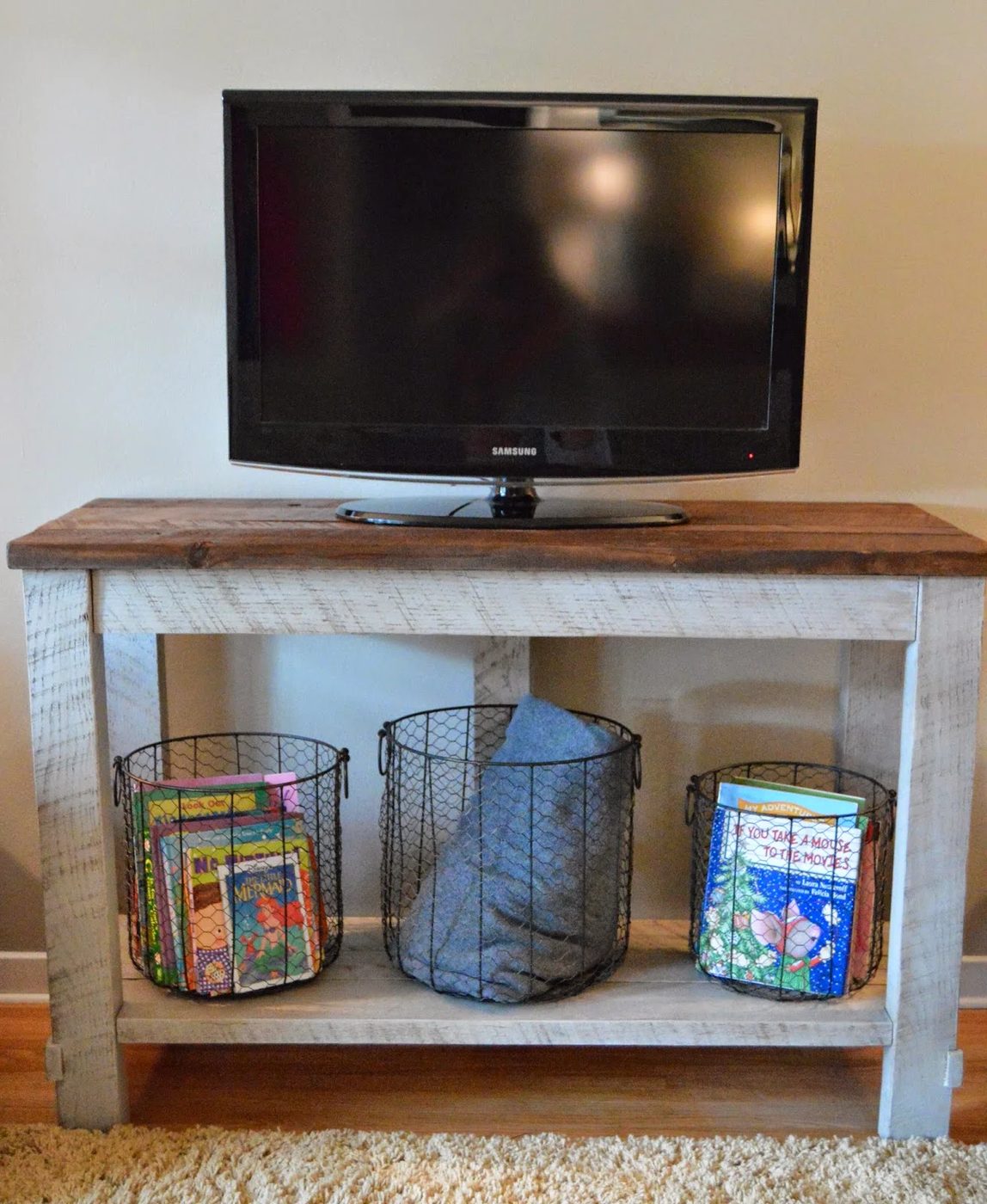 handmade reclaimed wood TV table that hides electronics cords (Kruse's Workshop via Tatertots and Jello)