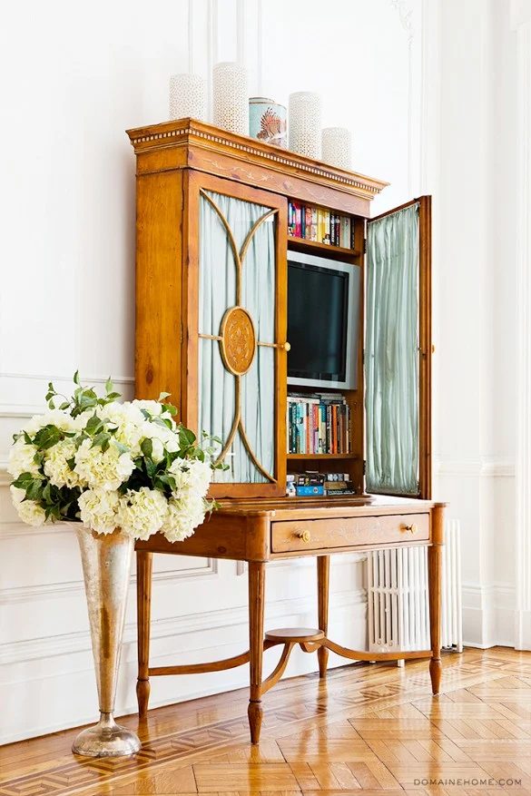 hide a television in a desk or shelving unit (My Domaine - Betsy Morgan)