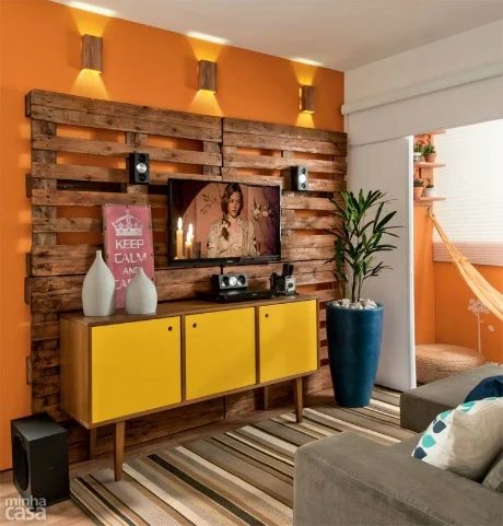 reclaimed wood pallet-style wall to hang television and hide cords (Minha Casa)