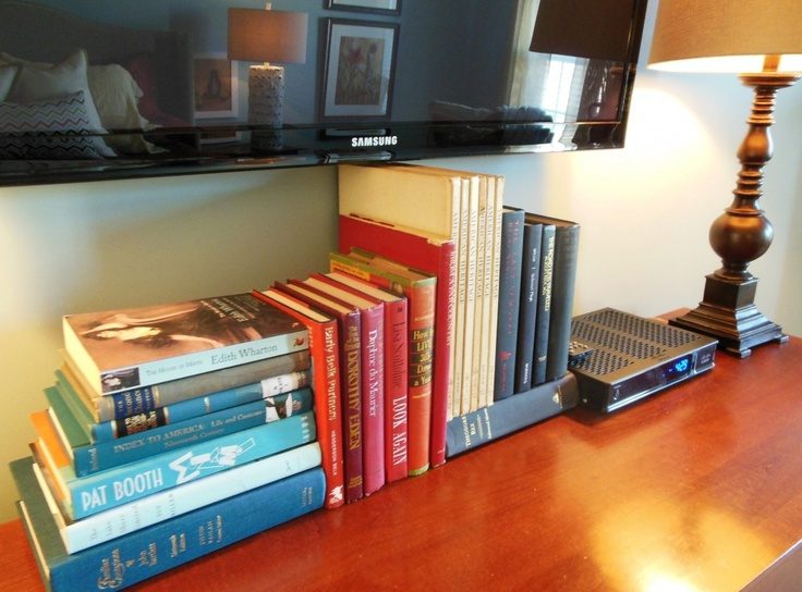 use stacks of books to hide TV cords and wires (via Love Coming Home)