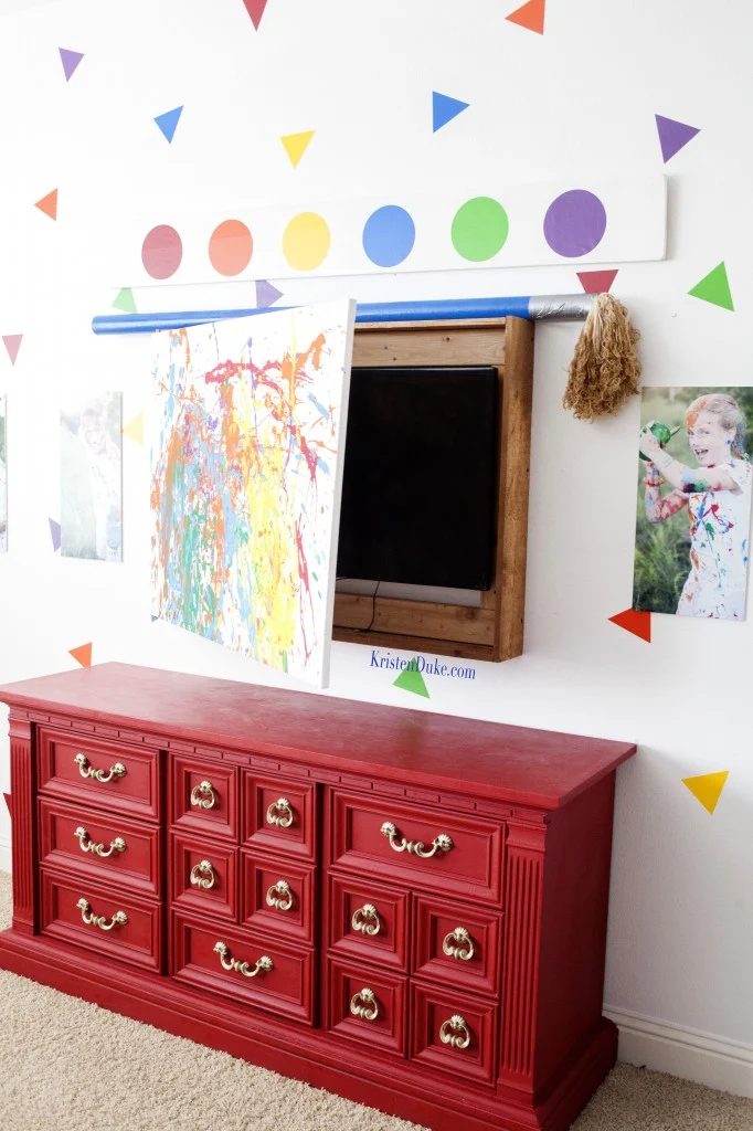 hide television behind kids artwork in a playroom (Kristen Duke Photography)
