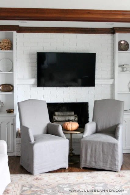 use hollow floating shelves for a mantel to hide television cords (Julie Blanner)