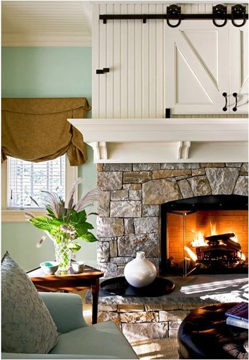hidden television behind barn doors in a mantel (Crisp Architects)