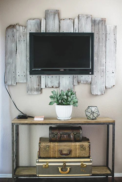 reclaimed wood whitewashed plank TV backdrop (via DesignSponge)