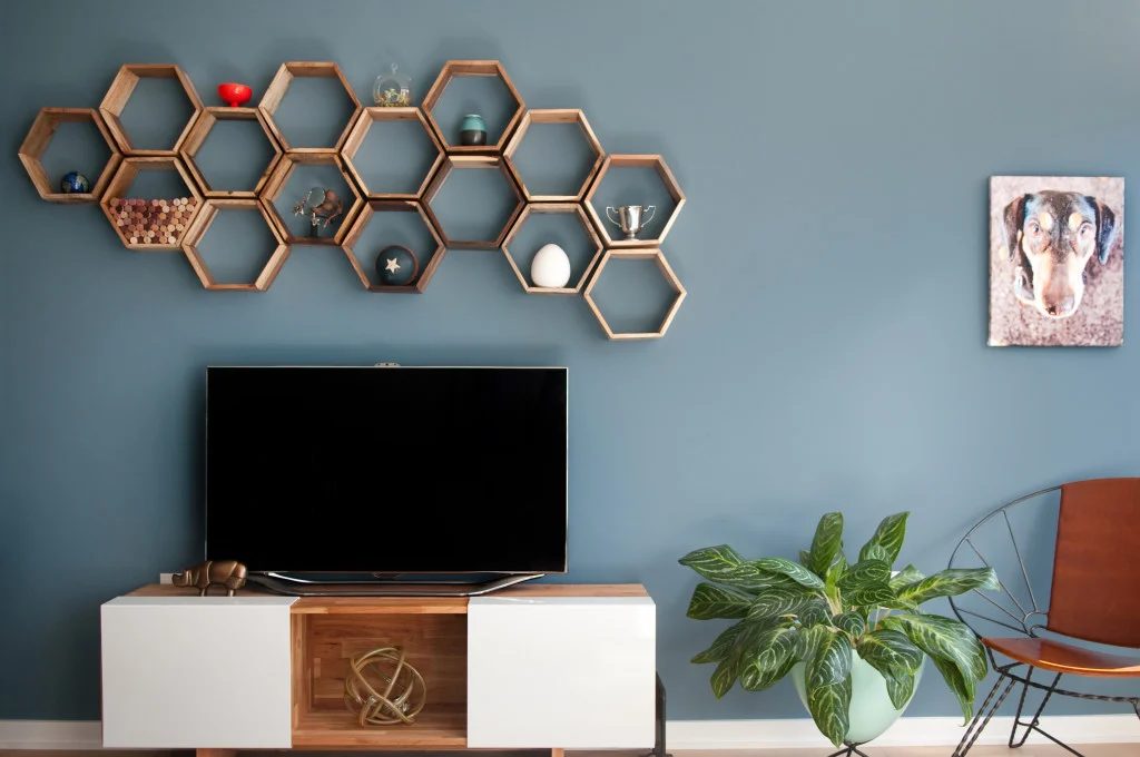 hexagonal geometric shelves above the TV (Monogram Decor)