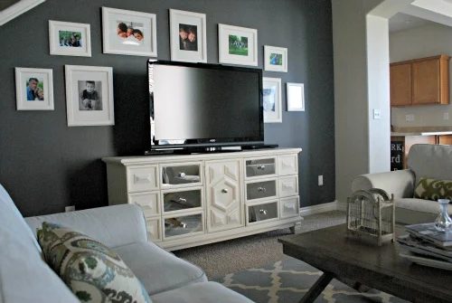 TV gallery wall, dark wall with light frames to hide the television (via Design Mom)