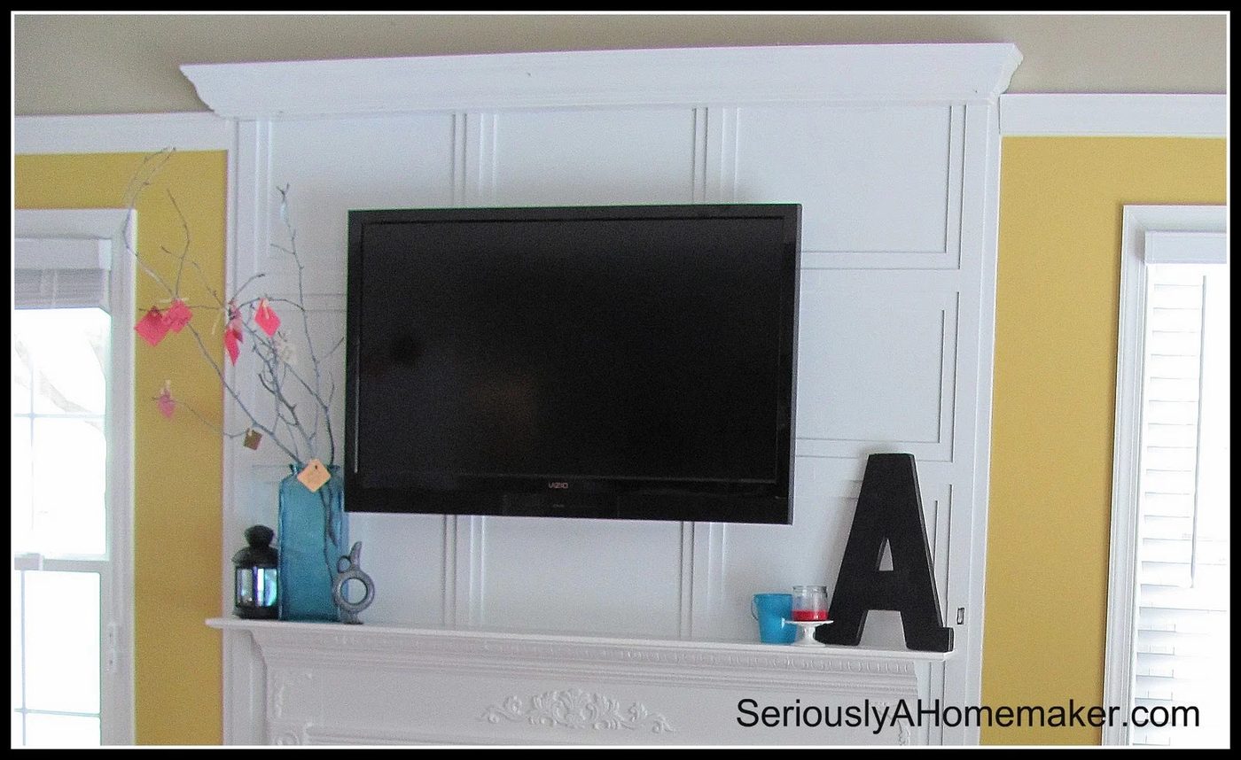 how to hide tv cords in trimwork above the mantel (via Sawdust Girl)