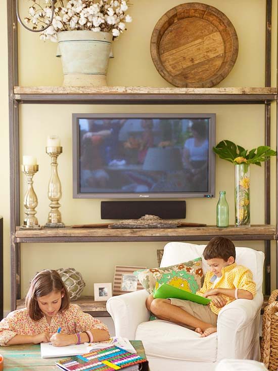 disguise a television in a large rustic shelving unit (BHG)