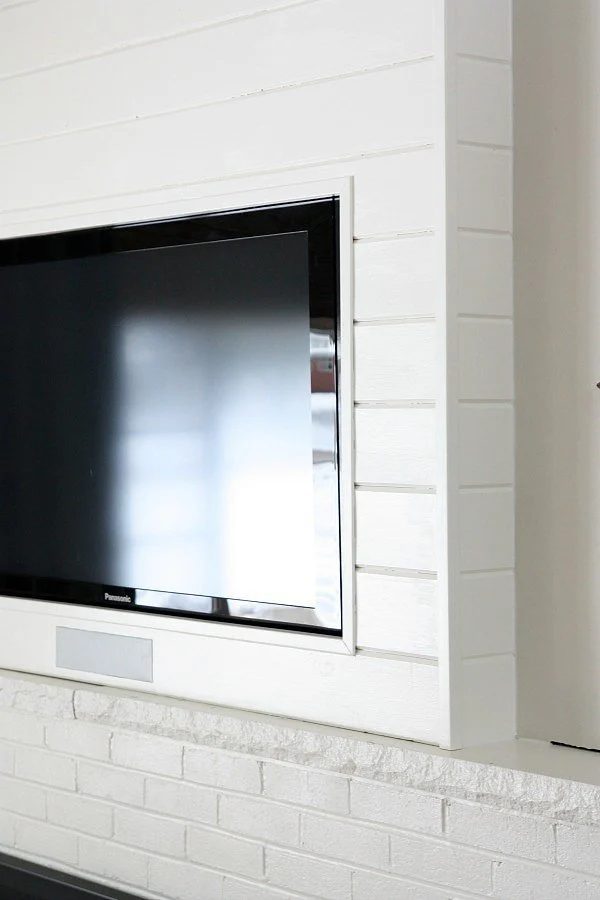 build a planked tv wall to hide the TV and cords (House Tweaking on PopSugar)