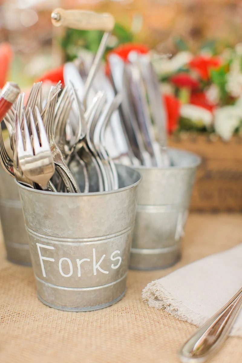 use inexpensive metal buckets to hold utensils for a party or wedding reception via Save On Crafts