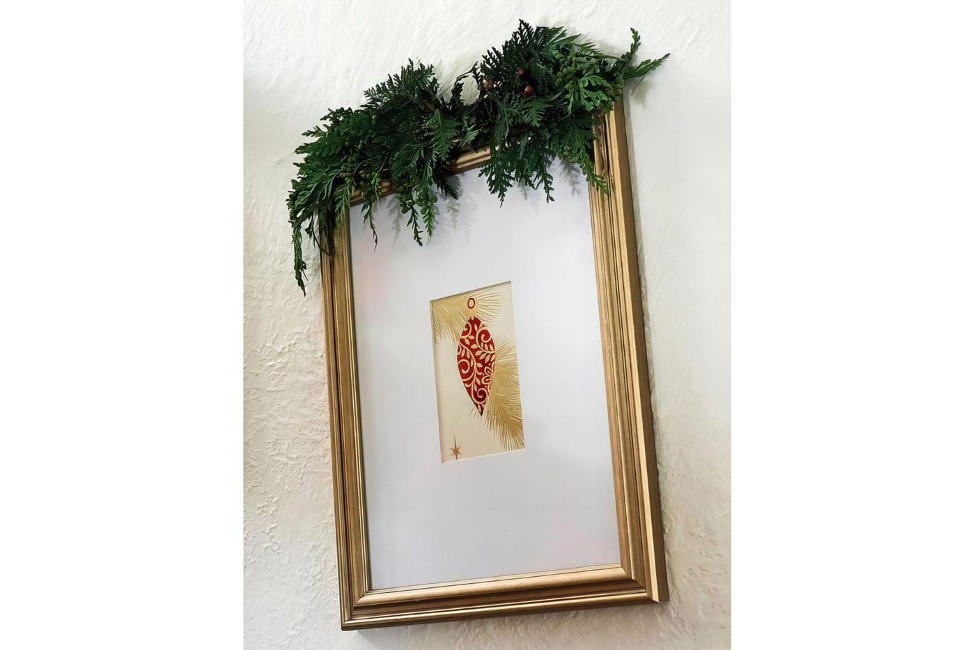 Fresh Evergreen Sprig On Top Of A Picture Frame BHG Via @Bekob 032942 Copy