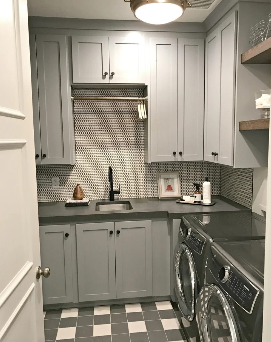 Laundry Room With Grey Cabinets, Tile, Washer And Dryer