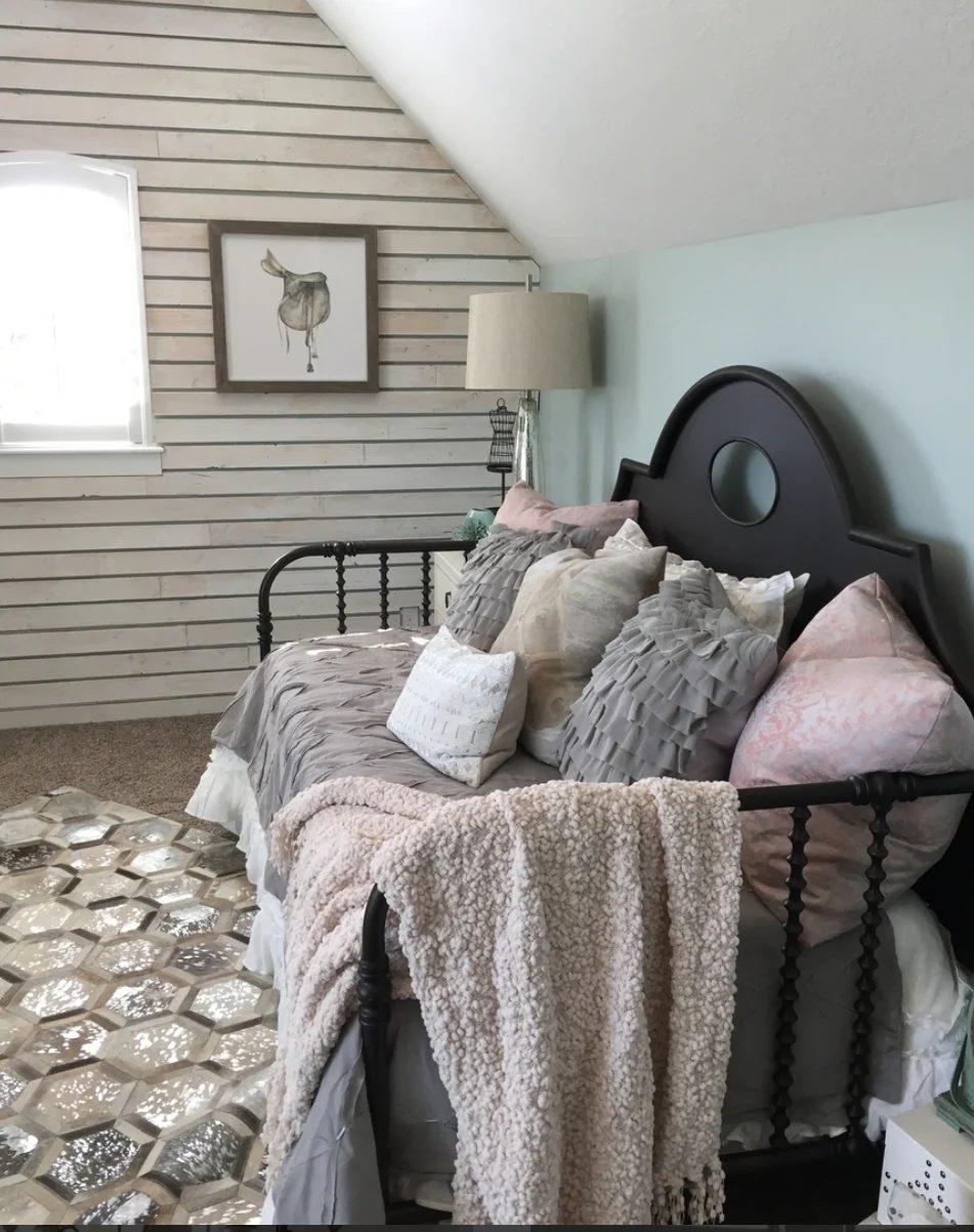 Bedroom With Black Bed, Grey, White And Pink Bedding, Wood Slab Wall And Blue Green Pastel Wall