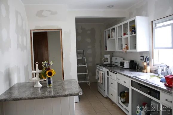 white kitchen remodel in progress, after thrifted cabinet installation