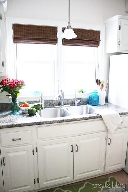 white kitchen with granite counter and stainless steel sink
