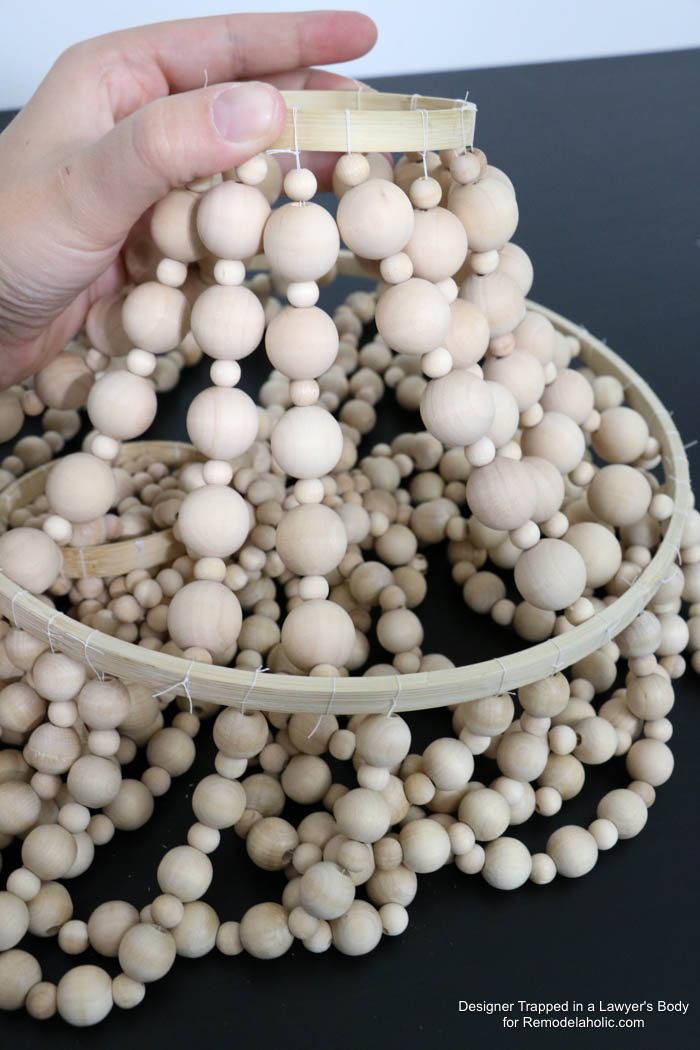 WOW! Come learn how to make your own wood bead chandelier with this solid walkthrough by Designer Trapped in a Lawyer's Body for Bekob.com!