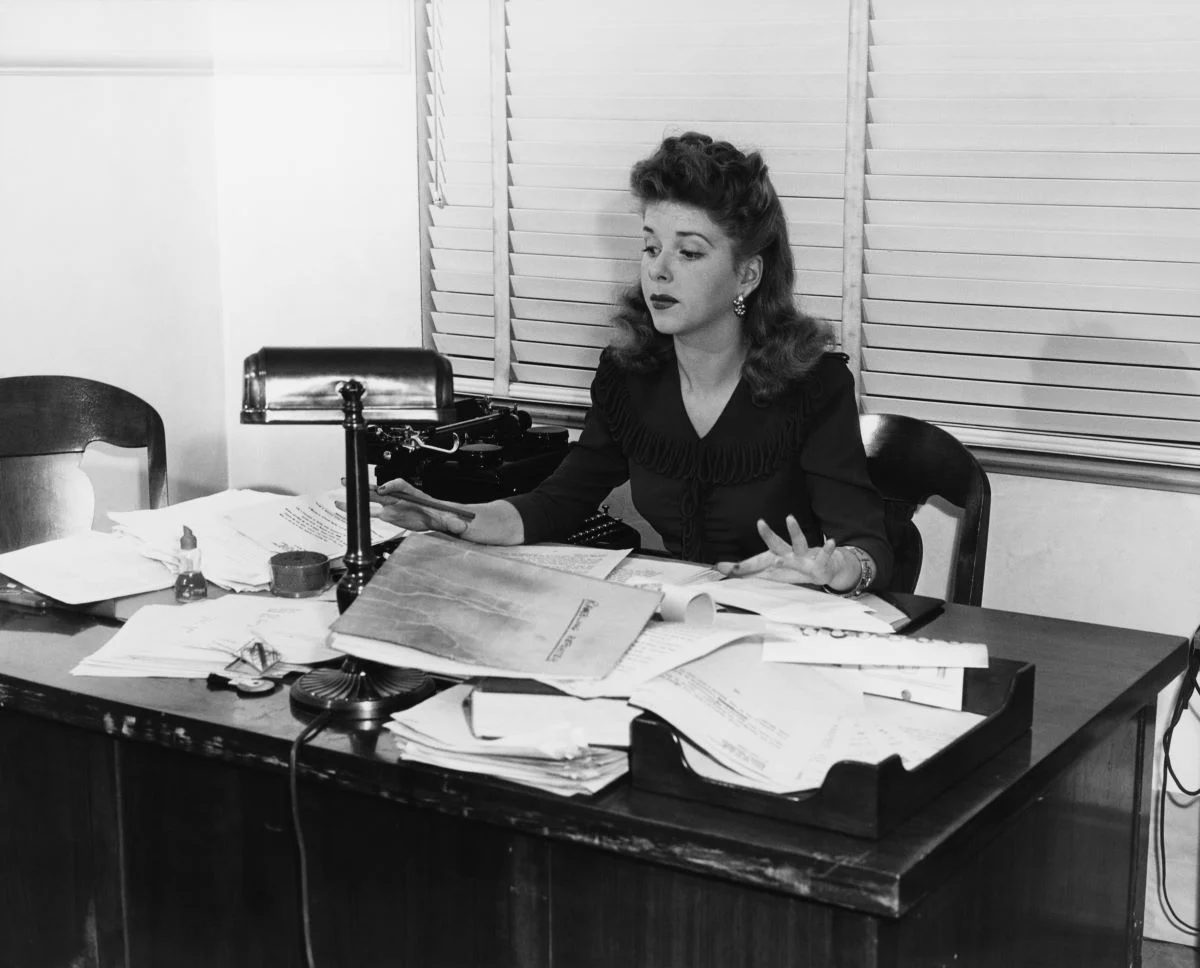 Cluttered Desk Lady Shutterstock 95079337