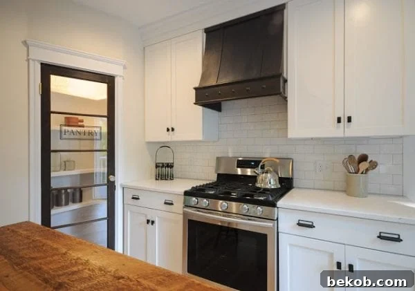 Custom Range Hood, Glass Pantry Door, and Reclaimed Wood Countertop